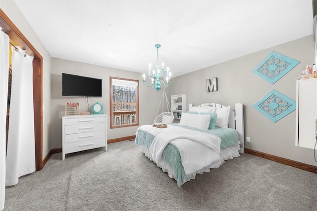 bedroom with baseboards, carpet floors, and a notable chandelier