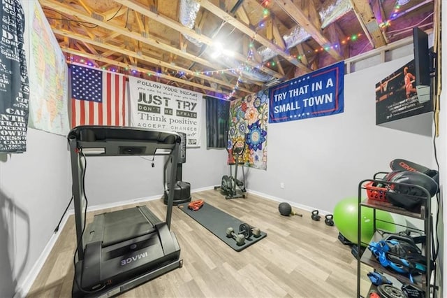 workout area featuring wood finished floors and baseboards