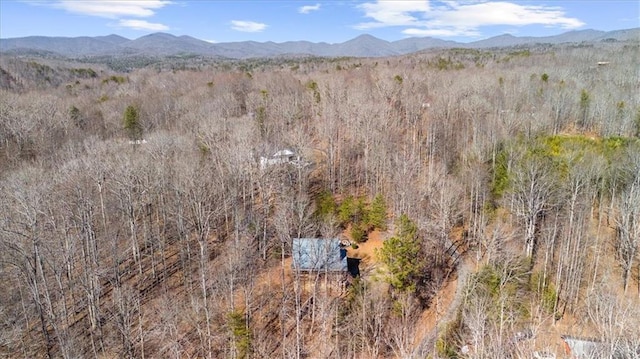 aerial view featuring a forest view and a mountain view