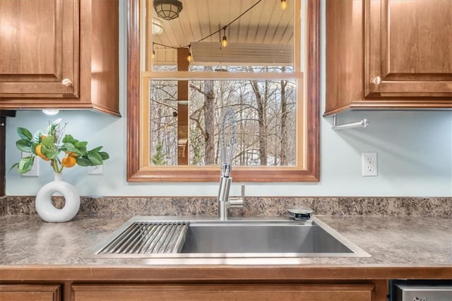 details featuring a sink and brown cabinets