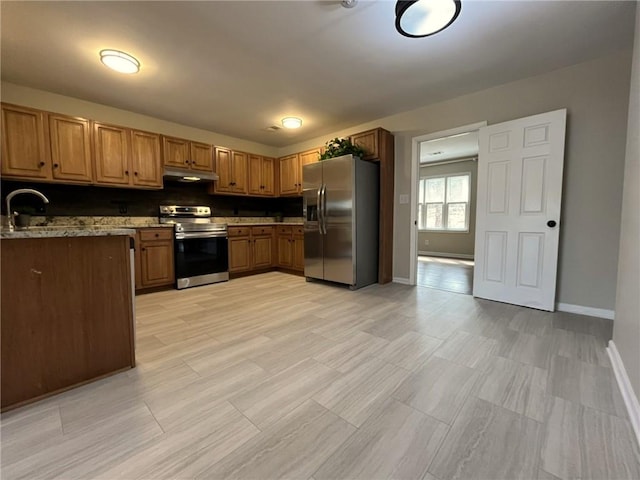 1929 Hazelwood Dr SE, Marietta, GA 30067 - kitchen with appliances with stainless steel finishes, under cabinet range hood, brown cabinets, and stone countertops
