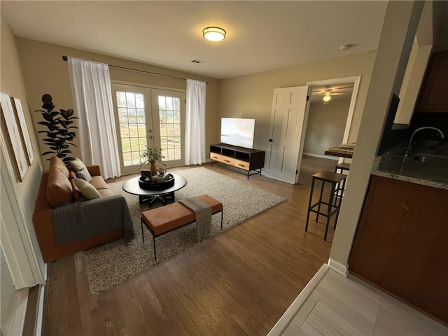 1929 Hazelwood Dr SE, Marietta, GA 30067 - living room with wood finished floors, french doors, and ceiling fan