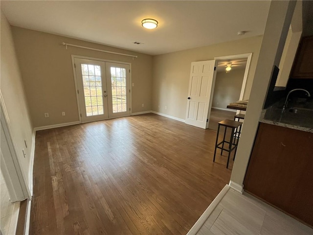 1929 Hazelwood Dr SE, Marietta, GA 30067 - spare room with wood finished floors, french doors, ceiling fan, and a smoke detector