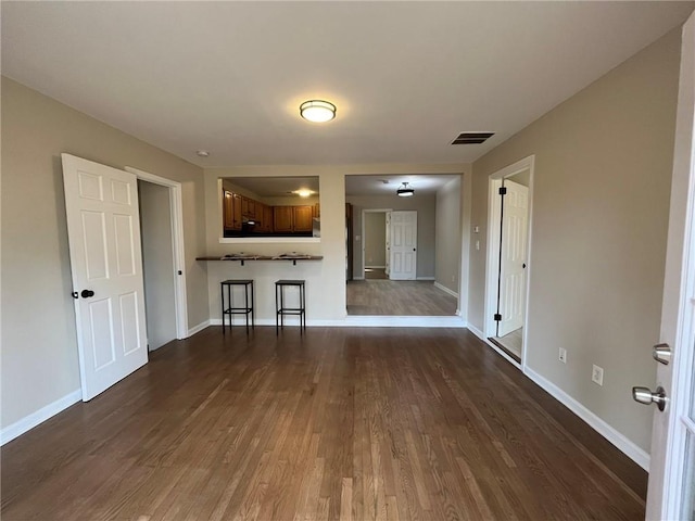 1929 Hazelwood Dr SE, Marietta, GA 30067 - unfurnished living room featuring dark wood-type flooring and baseboards