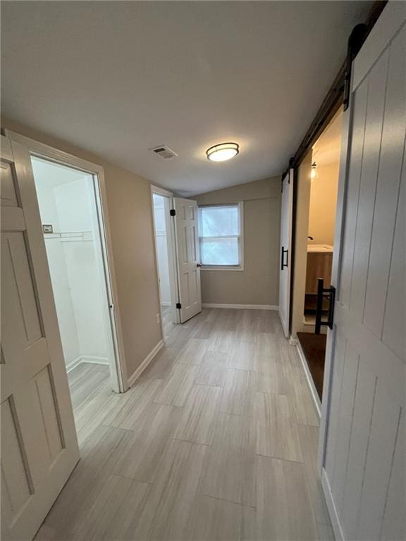 1929 Hazelwood Dr SE, Marietta, GA 30067 - corridor with a barn door and light wood-style floors