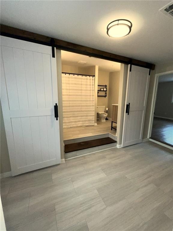 1929 Hazelwood Dr SE, Marietta, GA 30067 - corridor featuring a barn door and baseboards