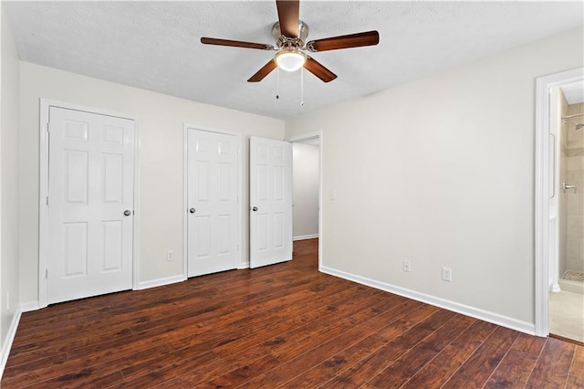 unfurnished bedroom featuring wood finished floors, baseboards, and ensuite bathroom