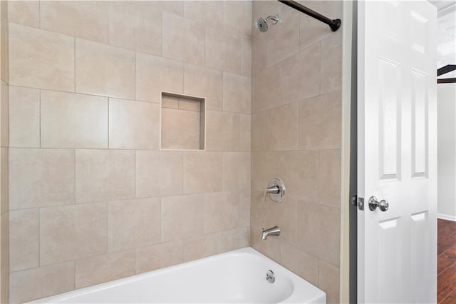 bathroom featuring bathtub / shower combination and wood finished floors