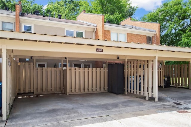rear view of property with fence and brick siding