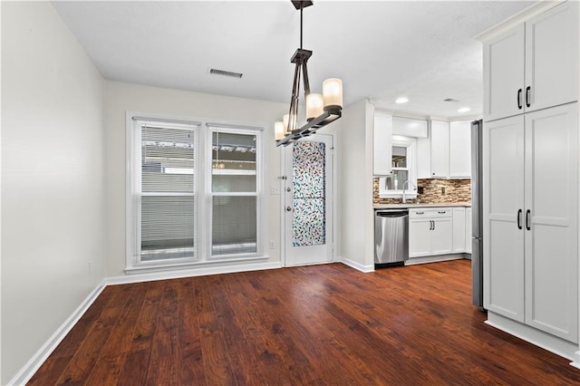kitchen featuring stainless steel dishwasher, a chandelier, baseboards, dark wood-style flooring, and recessed lighting