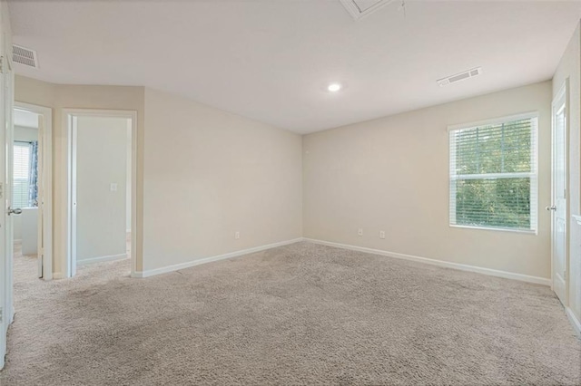 carpeted spare room featuring a wealth of natural light