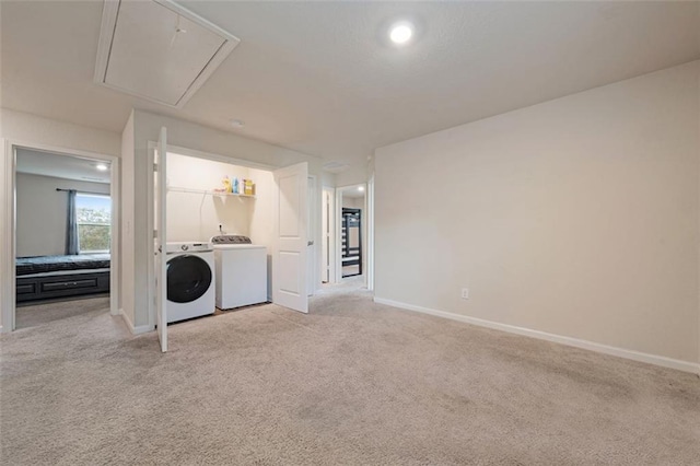 washroom with washer and dryer and light colored carpet