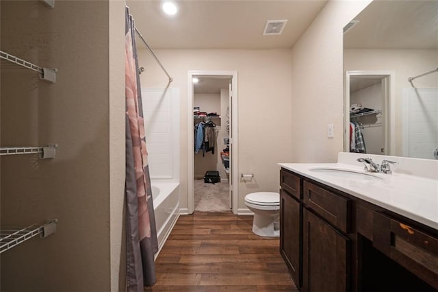 full bathroom featuring wood-type flooring, vanity, toilet, and shower / bath combo with shower curtain