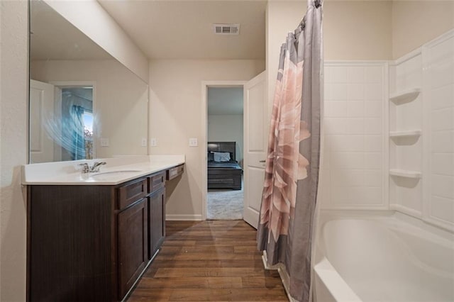 bathroom featuring vanity, hardwood / wood-style flooring, and shower / tub combo with curtain