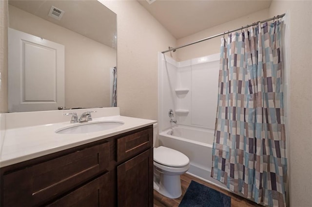 full bathroom featuring hardwood / wood-style floors, vanity, toilet, and shower / bathtub combination with curtain