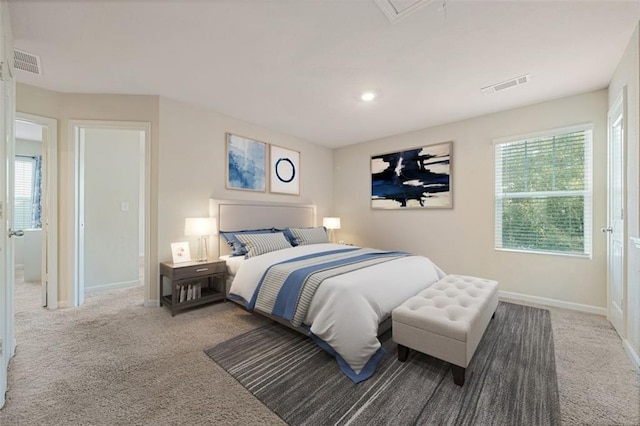 carpeted bedroom featuring multiple windows