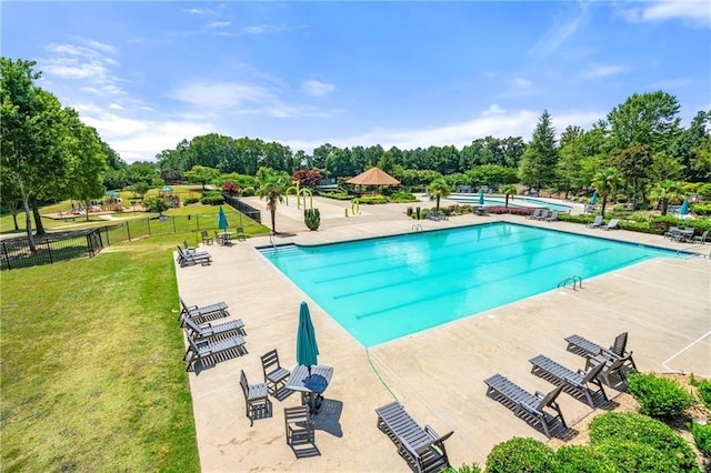 view of swimming pool with a lawn and a patio area