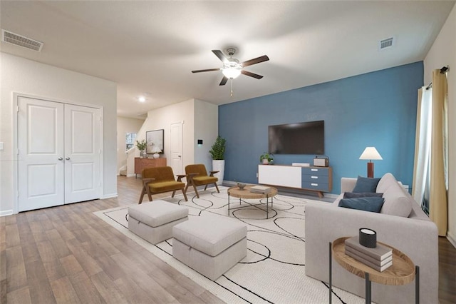 living room featuring hardwood / wood-style flooring and ceiling fan