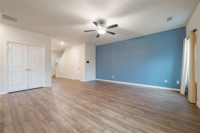 unfurnished room featuring ceiling fan and wood-type flooring