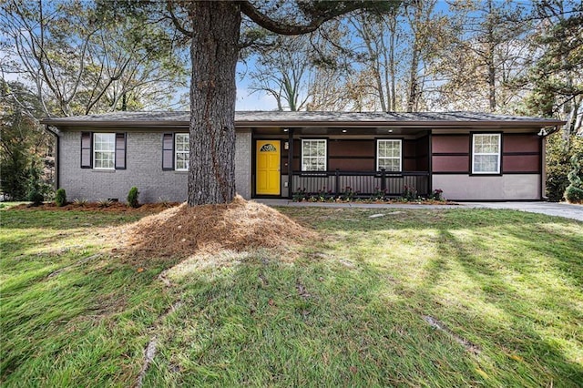 single story home with covered porch, brick siding, and a front yard