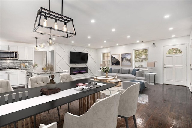 living room featuring recessed lighting and dark wood-style flooring