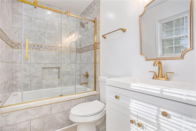 bathroom featuring vanity, toilet, and tiled shower / bath combo