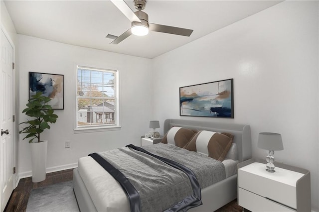 bedroom featuring baseboards, dark wood-style flooring, and ceiling fan