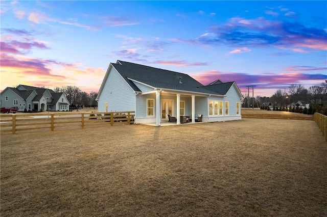 rear view of house featuring a patio and a fenced backyard