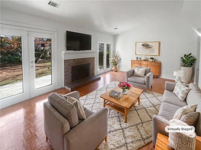 4727 Garden Hills Dr, Stone Mountain, GA 30083 - living room featuring french doors, lofted ceiling, and a brick fireplace