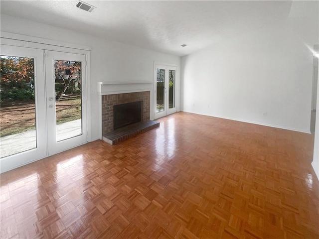 4727 Garden Hills Dr, Stone Mountain, GA 30083 - unfurnished living room featuring french doors and a brick fireplace