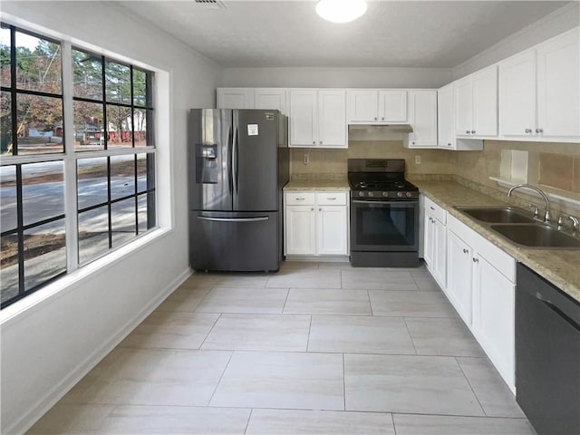 4727 Garden Hills Dr, Stone Mountain, GA 30083 - kitchen with stainless steel fridge, gas stove, dishwasher, white cabinetry, and light stone countertops