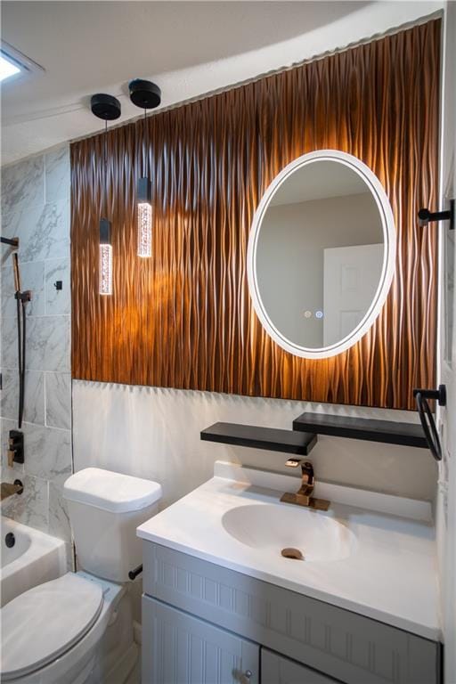 5072 Plantation View Trl, Stone Mountain, GA 30088 - bathroom featuring vanity, tile walls, shower / tub combination, and toilet