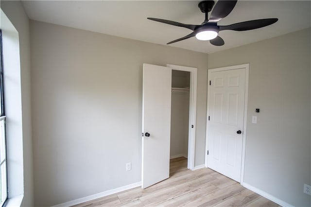 5072 Plantation View Trl, Stone Mountain, GA 30088 - unfurnished bedroom featuring light wood-style flooring, a closet, baseboards, and ceiling fan