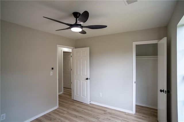 5072 Plantation View Trl, Stone Mountain, GA 30088 - unfurnished bedroom with a closet, light wood-style flooring, baseboards, and a ceiling fan