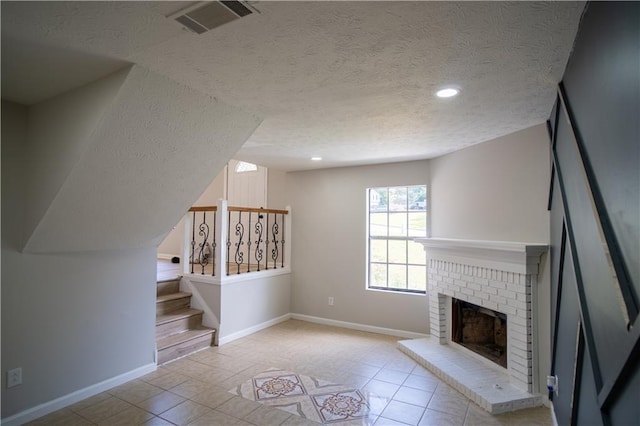 5072 Plantation View Trl, Stone Mountain, GA 30088 - unfurnished living room featuring a textured ceiling, baseboards, tile patterned floors, a brick fireplace, and recessed lighting