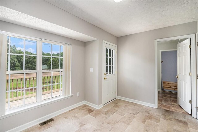 350 Dailey Mill Rd, Mcdonough, GA 30253 - foyer entrance featuring a textured ceiling and stone finish floors