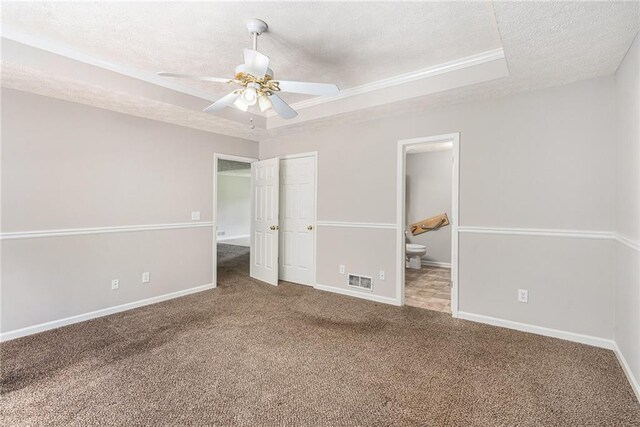 350 Dailey Mill Rd, Mcdonough, GA 30253 - unfurnished bedroom with a textured ceiling, carpet flooring, ensuite bath, a raised ceiling, and ceiling fan