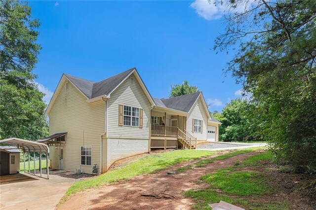 350 Dailey Mill Rd, Mcdonough, GA 30253 - view of front of property featuring a detached carport, a porch, concrete driveway, brick siding, and a storage shed