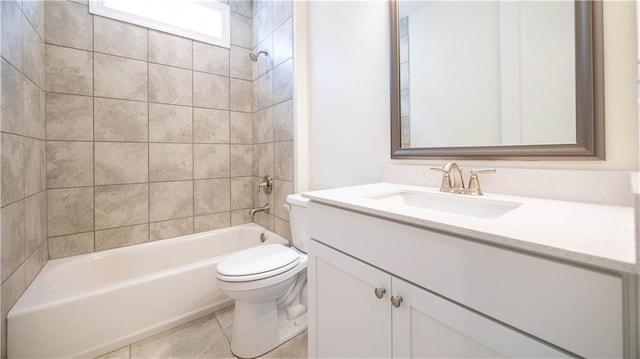 full bathroom featuring tiled shower / bath combo, vanity, toilet, and tile patterned floors