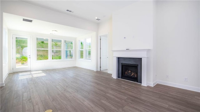 unfurnished living room with dark wood-type flooring