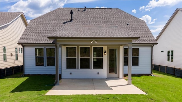 rear view of house featuring a patio and a lawn