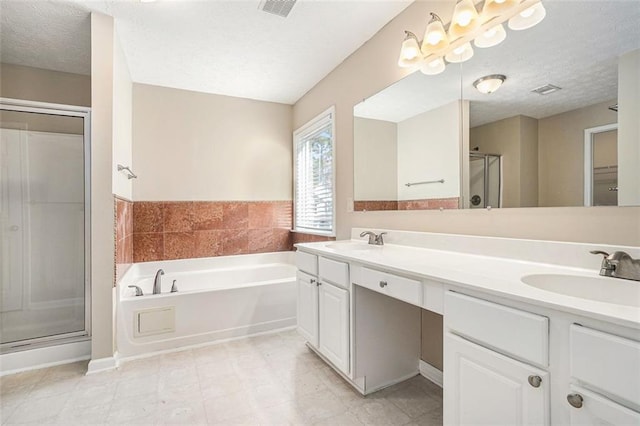 bathroom with a textured ceiling, plus walk in shower, and vanity