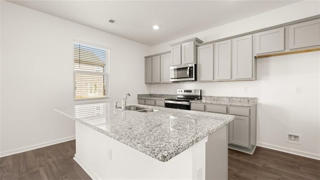605 Lobelia Way, Locust Grove, GA 30248 - kitchen with appliances with stainless steel finishes, gray cabinetry, a sink, baseboards, and dark wood finished floors