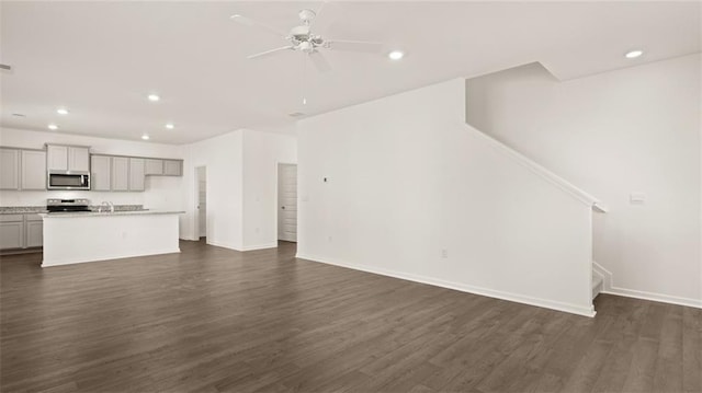 605 Lobelia Way, Locust Grove, GA 30248 - unfurnished living room with recessed lighting, a ceiling fan, dark wood-type flooring, baseboards, and stairs