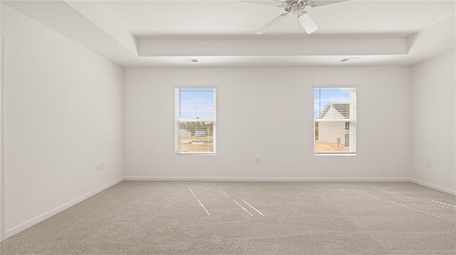 605 Lobelia Way, Locust Grove, GA 30248 - carpeted spare room featuring a raised ceiling, baseboards, and a ceiling fan