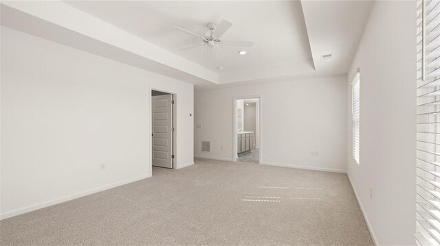 605 Lobelia Way, Locust Grove, GA 30248 - unfurnished bedroom featuring a raised ceiling, light colored carpet, ensuite bath, and recessed lighting