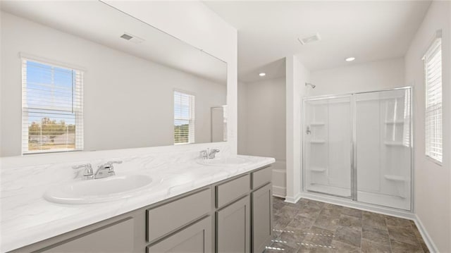 605 Lobelia Way, Locust Grove, GA 30248 - bathroom featuring a shower stall, healthy amount of natural light, baseboards, double vanity, and recessed lighting