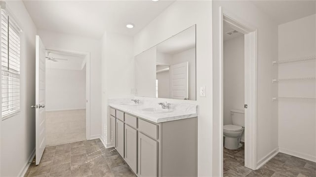 605 Lobelia Way, Locust Grove, GA 30248 - bathroom featuring toilet, a ceiling fan, double vanity, and baseboards