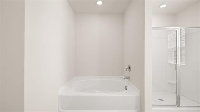605 Lobelia Way, Locust Grove, GA 30248 - bathroom featuring a stall shower, a bath, and recessed lighting