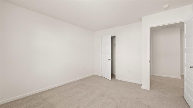 605 Lobelia Way, Locust Grove, GA 30248 - unfurnished bedroom with light colored carpet, baseboards, and a closet